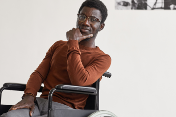 A young gentleman in a wheelchair looking at the camera