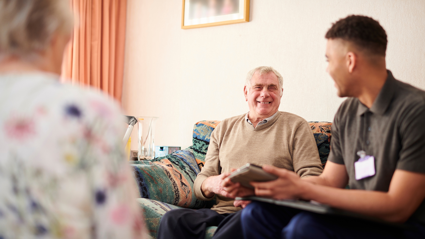 A young professional man taking to an elderly gentleman