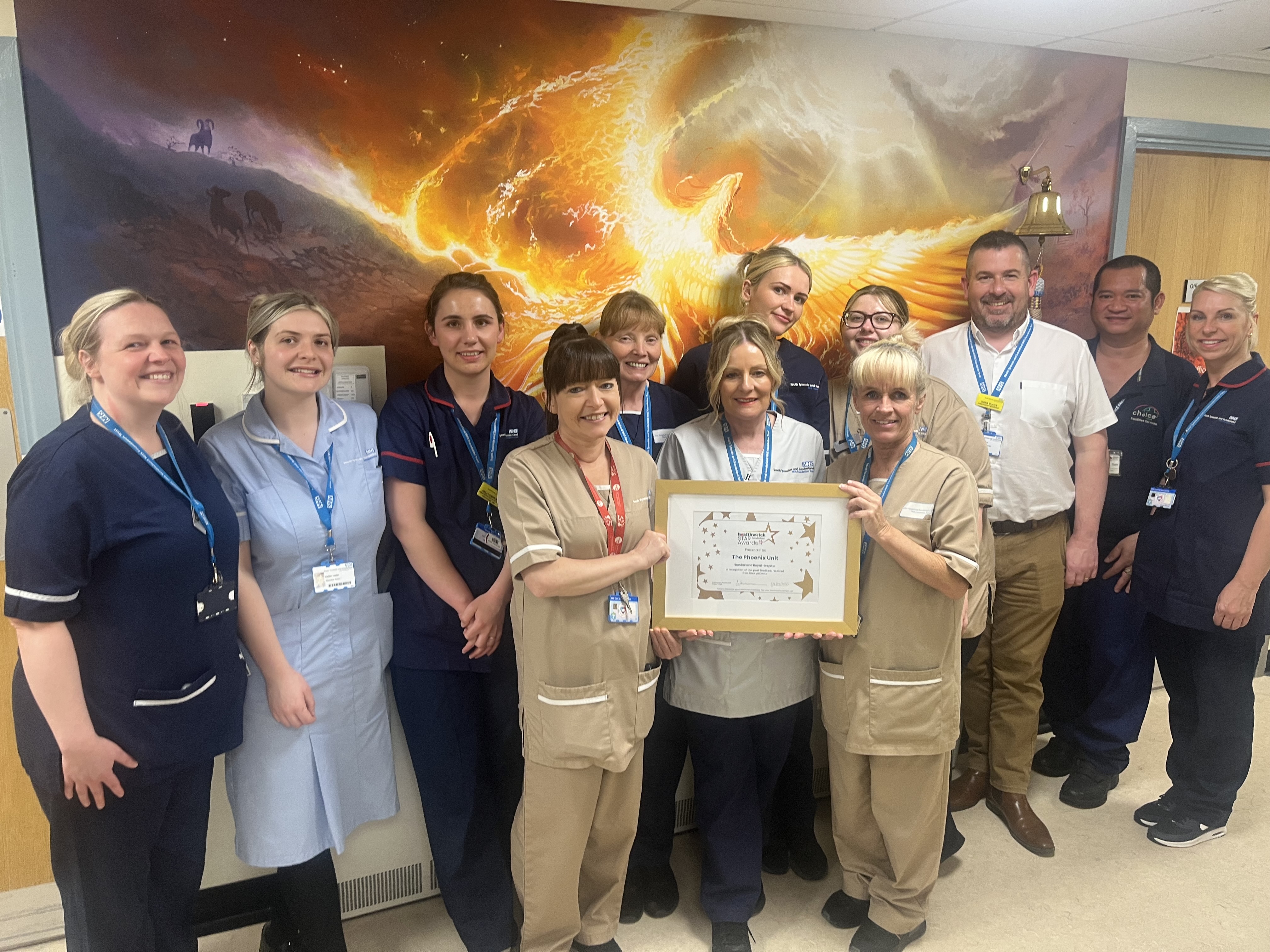 A group of people looking at the camera holding a certificate