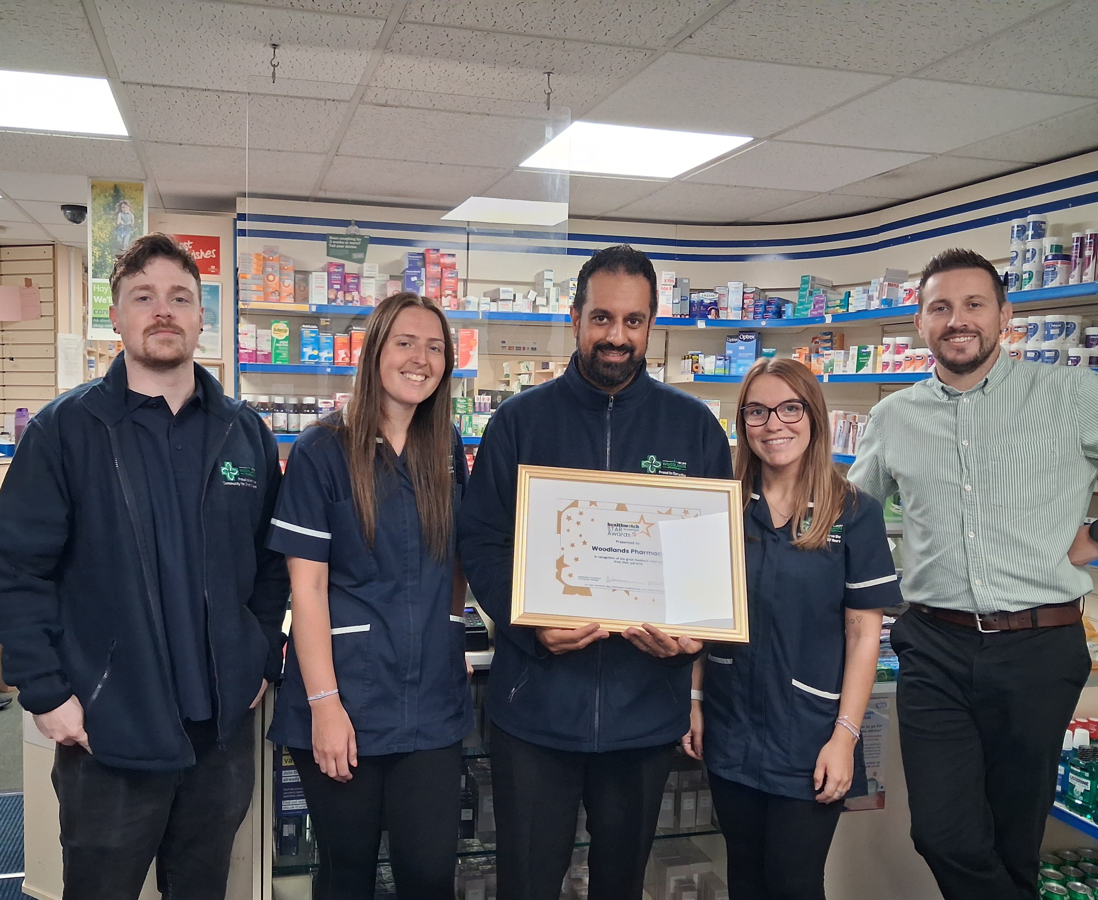People standing looking at the camera holding a certificate