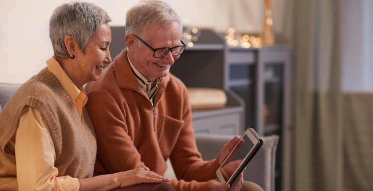 Two people looking on a tablet