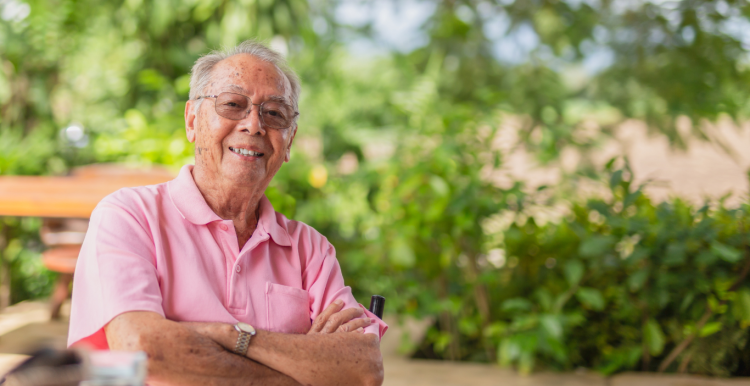 A gentleman standing smiling at the camera