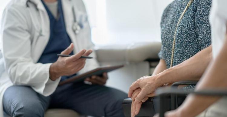 A couple holding hands in a doctor's office