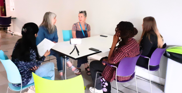 A group of women sitting at a table talking