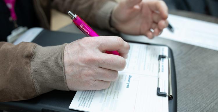 An image of a person's hand using a pen
