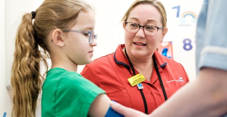 A nurse talking to a young patient