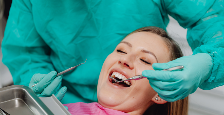 A lady having her teeth checked by a dentist