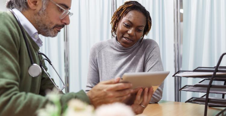 A doctor talking to a patient in his surgery practice