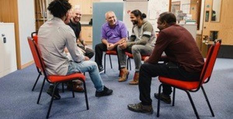 Men chatting in a mental health support group