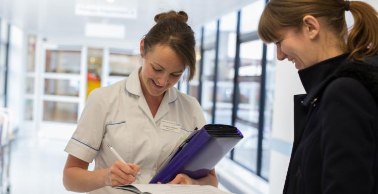 Nurse speaking to a patient in a hospital