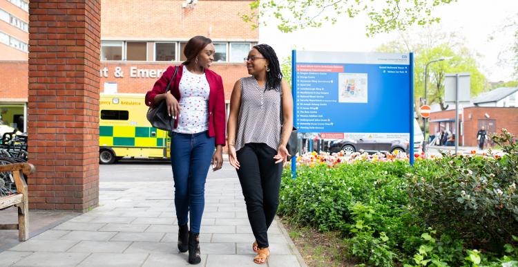 Two people walking outside A&E Two people walking outside A&E