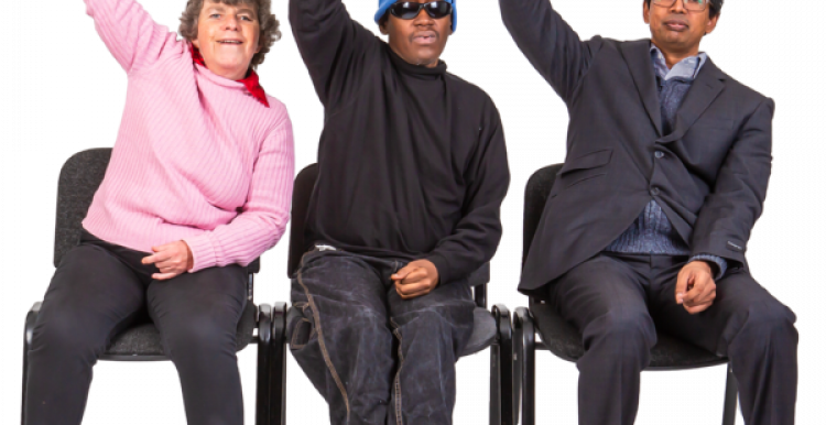 Three people sitting on a chair with one arm in the air