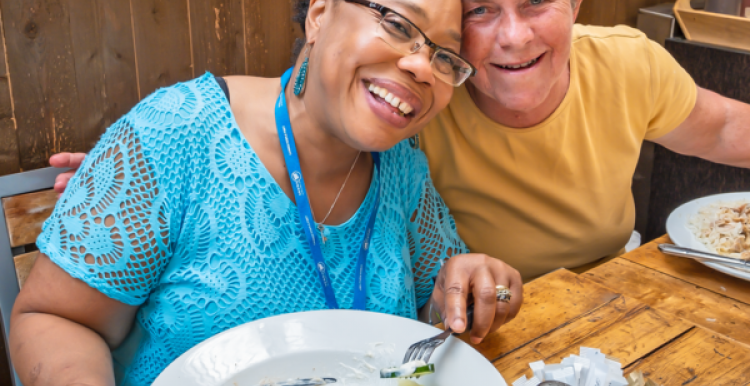 Two people sitting in a cafe eating a meal Two people sitting in a cafe eating a meal