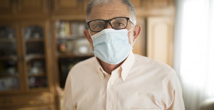 Man in care home wearing a face mask Man in care home wearing a face mask