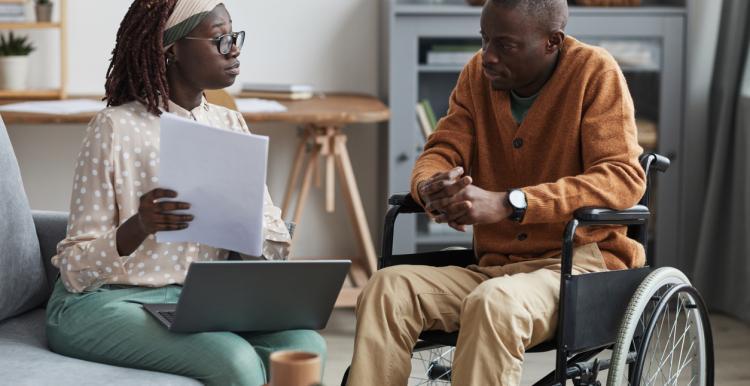 Woman talking to a man in a wheelchair