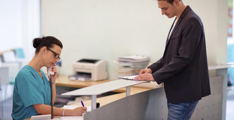 Man talking to a receptionist