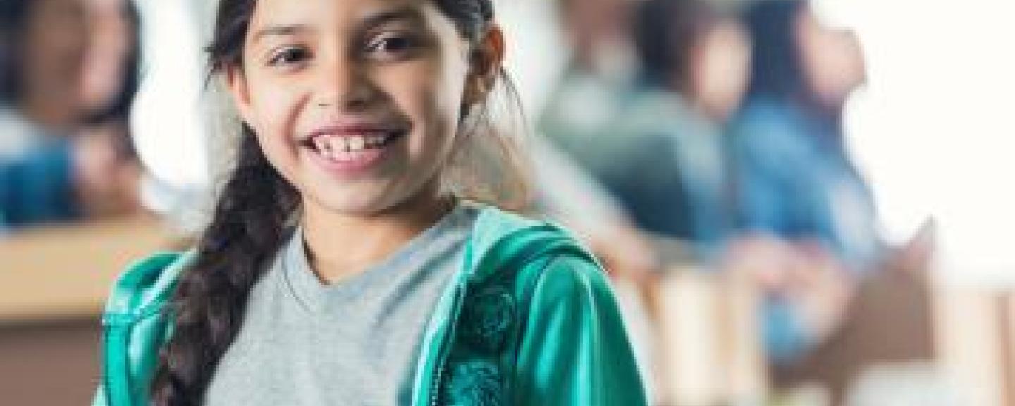 Young girl with long braided hair smiling