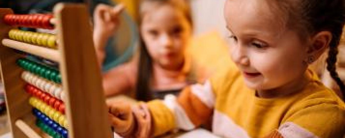 Young girl playing with an abacus