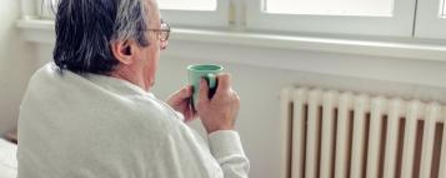 A man sitting in a chair looking out of the window