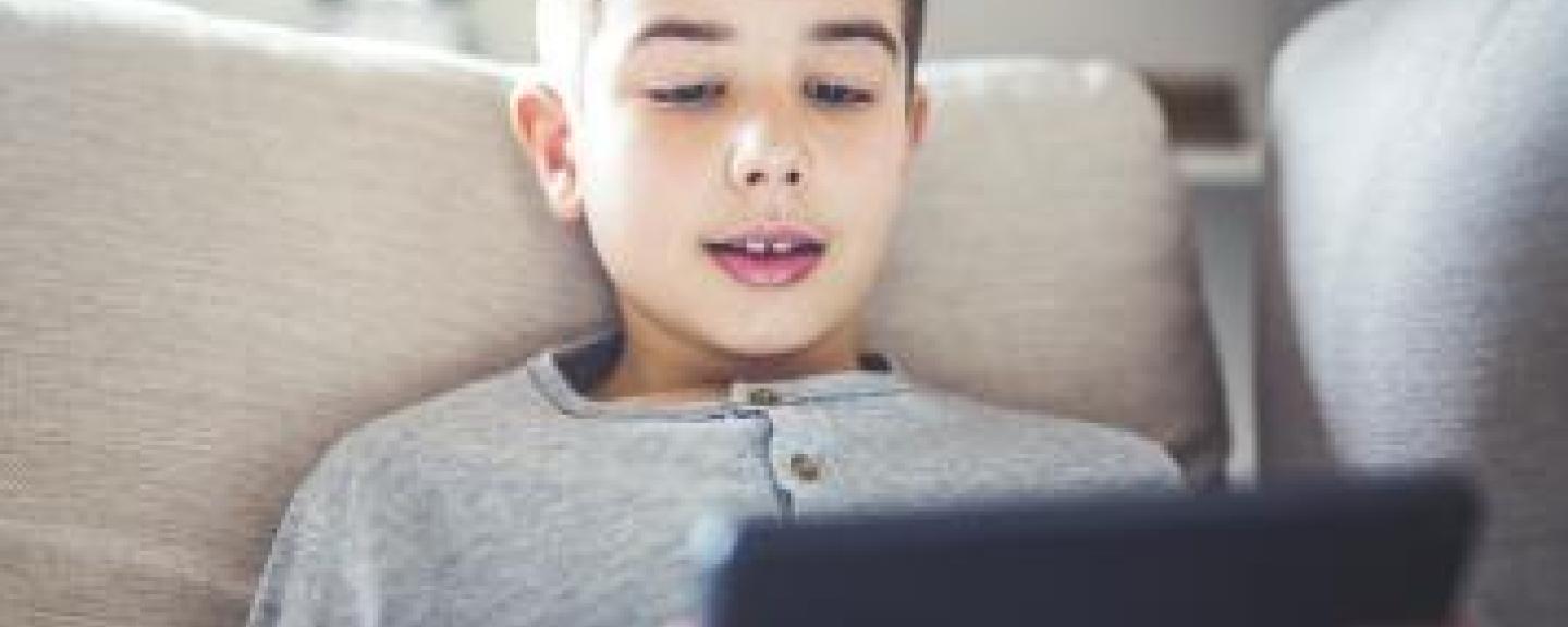 Young boy looking at a tablet screen