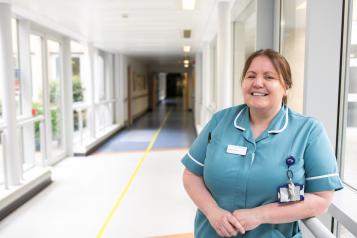 A nurse standing in a hallway in a hospital
