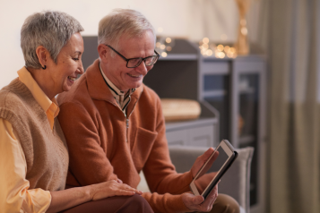 Two people looking on a tablet