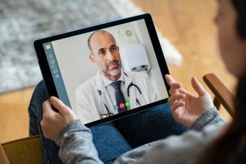 Someone looking at a computer tablet