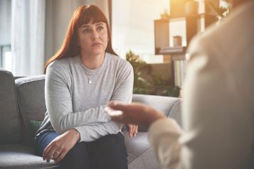 A woman sitting and talking to another person