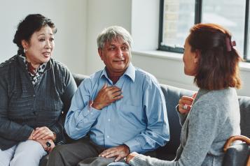 Three people sitting and talking to one another