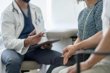 A couple holding hands in a doctor's office