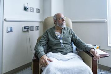A man sitting in a hospital chair