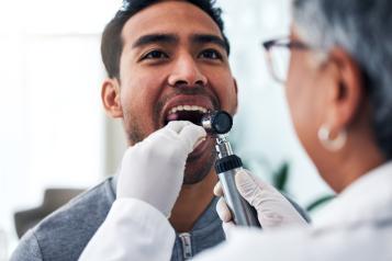 A dentist looking into a patient's mouth