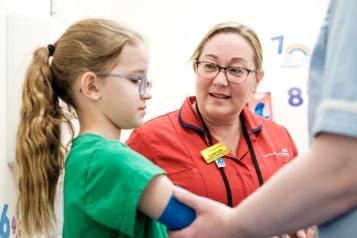 A nurse talking to a young patient