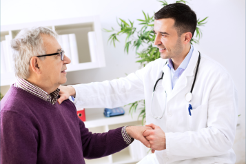 A doctor talking to a patient in his surgery practice