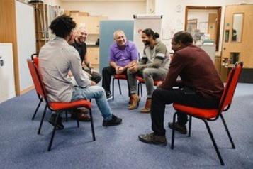 Men chatting in a mental health support group