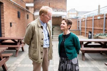 A man and a woman talking to one another