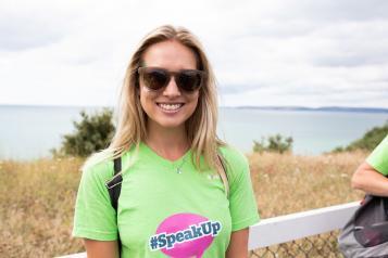 Woman wearing a Healthwatch t-shirt and sunglasses