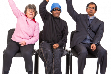 Three people sitting on a chair with one arm in the air