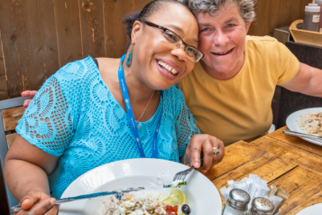 Two people sitting in a cafe eating a meal