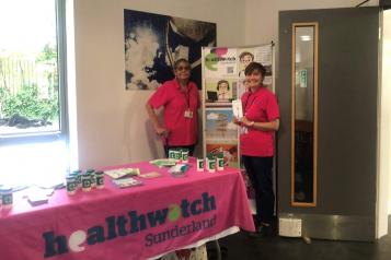 Two women at a Healthwatch Sunderland engagement event smiling at the camera