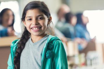 Young girl with long braided hair smiling