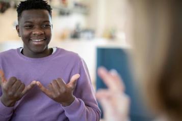 Teenage boy and girl having a conversation using sign language