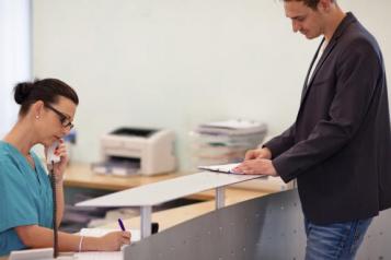 Man talking to a receptionist