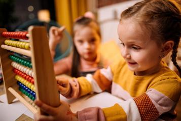 Young girl playing with an abacus