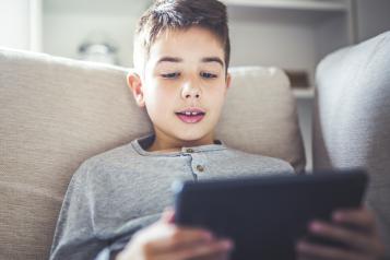 Young boy looking at a tablet screen
