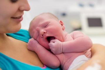 A woman holding a newborn
