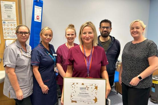 A group of people looking at the camera holding a certificate
