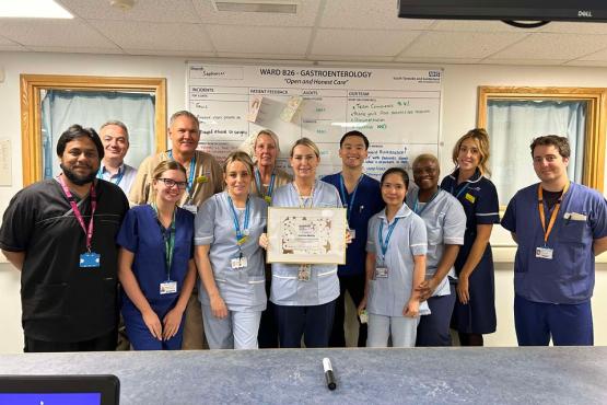 A group of people looking at the camera holding a certificate