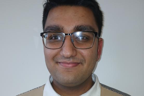 A young man smiling at the camera