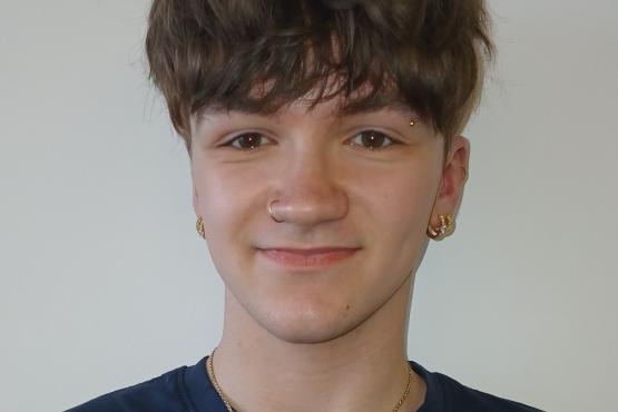 A young man smiling at the camera